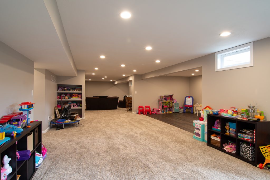 Contemporary Gibsonia Basement with Warm Tones and Optional Use of Space.