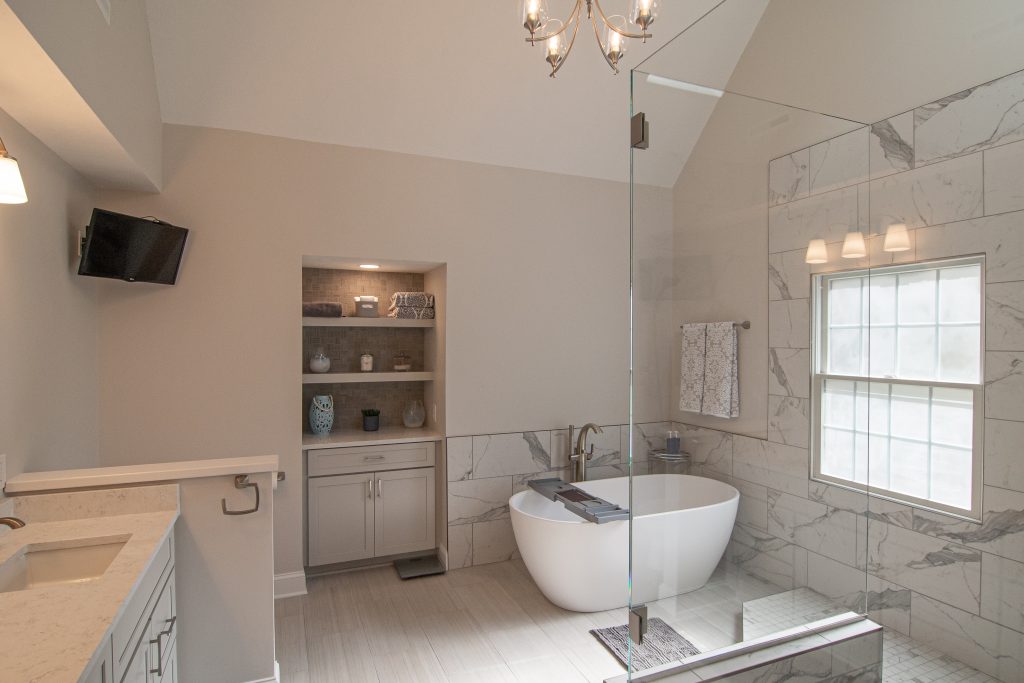 Modern take on an Allison Park Master Bathroom focusing on architectural lines and custom cut clear glass walk in shower