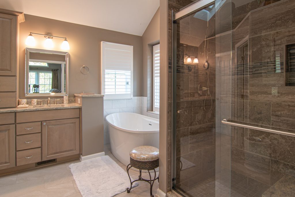 Fox Chapel Transitional Bathroom with Herring Bone Floors, Painted Wood Cabinets and Quartz Counter Tops.