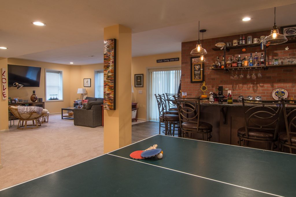 Transforming A Murrysville Basement Into A New Entertainment Area With Lighter And Darker Warm Tone.
