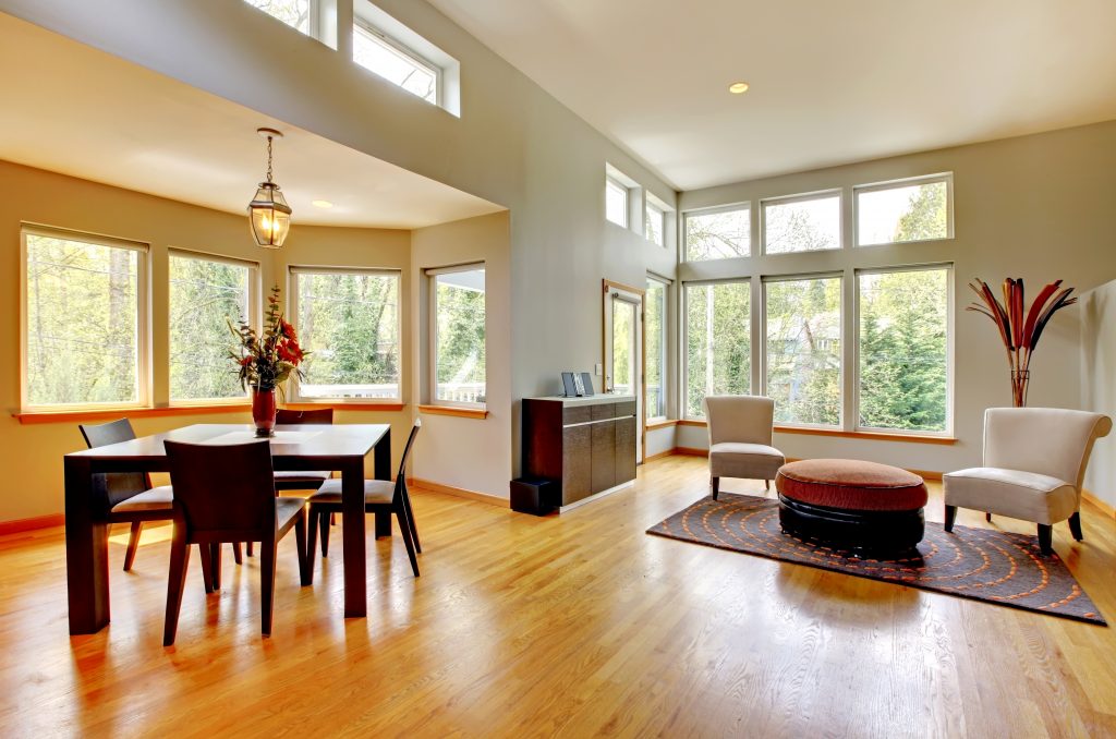 Fantastic modern living room home interior. Dining room. Huge green bright room with modern furniture.