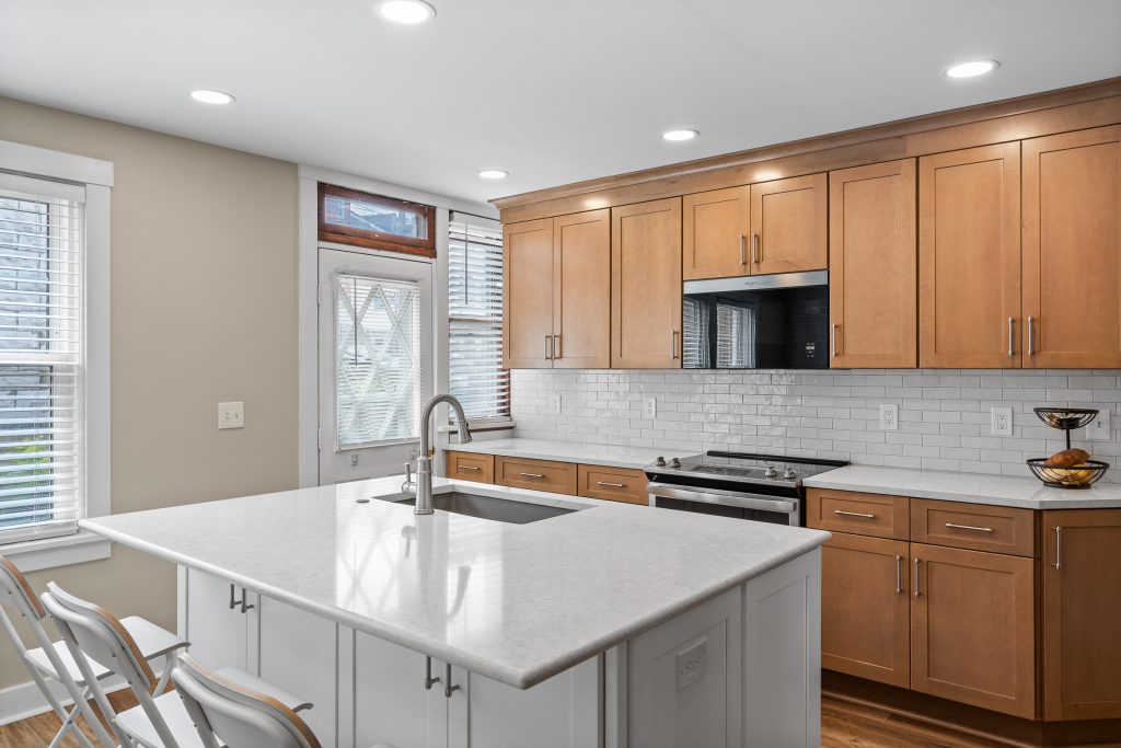 Picture of a Mars, PA, kitchen featuring light wood cabinets, white countertops, and a white tile backsplash for a clean and modern design that focuses on functionality and comfort.