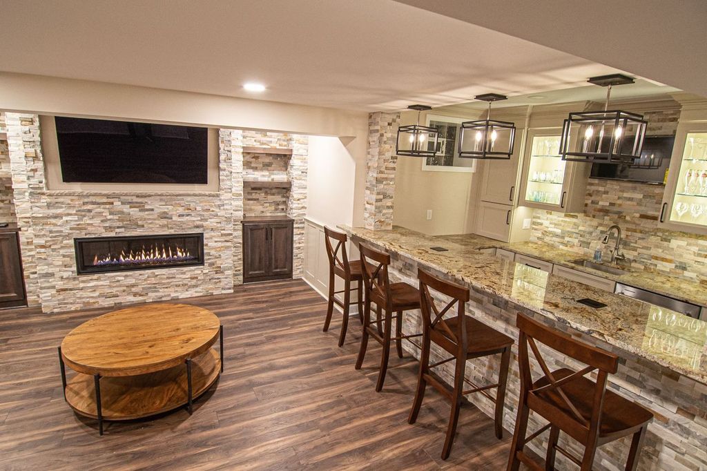 Picture of a modern Mt. Lebanon, PA, basement showing warm colors, straight-lined cabinets, and stacked stone.
