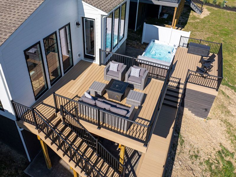 Luxurious McCandless Two-Level Deck Showcasing a Hot Tub and Patio Furniture, Offering a Tranquil Outdoor Living Space.