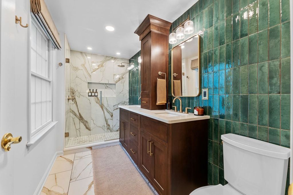 This McCandless Bathroom Features a Sophisticated and Rich Design with a Balanced Blend of Textures and Color. Overall, the Space is a Blend of Classic and Modern Elements, Creating a Luxurious Atmosphere with a Bold Color Palette.