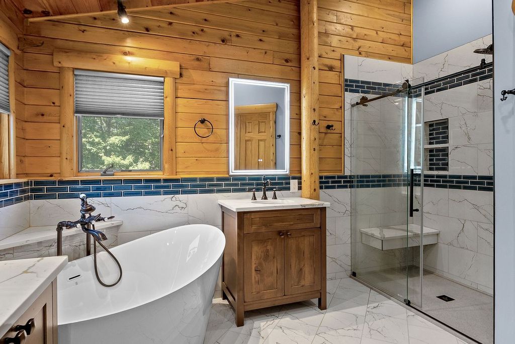 Modern Cranberry Bathroom Featuring Free Standing Bath and A Pop of Royal Blue Paint