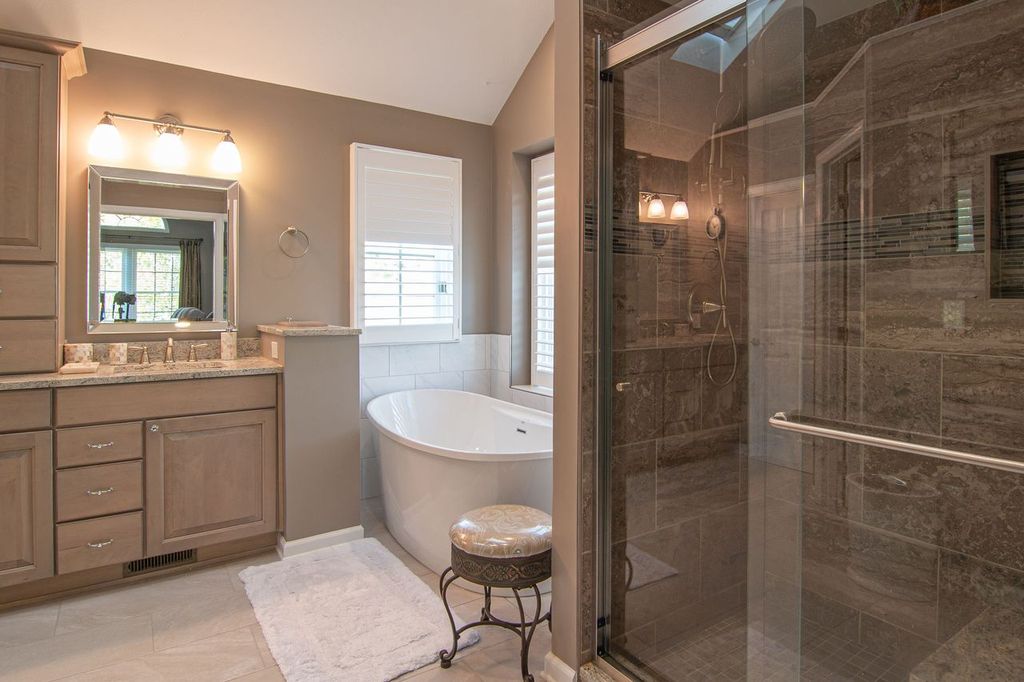 Transitional Style Venetia Bathroom with Herring Bone Floors, Painted Wood Cabinets and Quartz Counter Tops