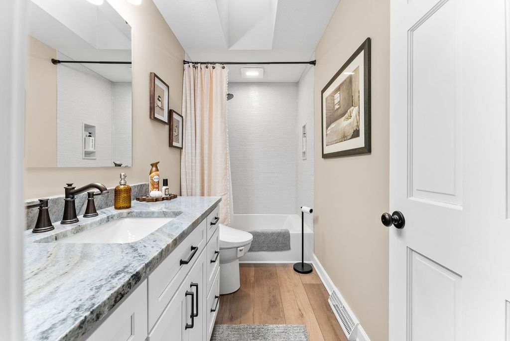 Neutral O’Hara Township Guest Bathroom with a Clean Minimalist Design Creating a Sense of Calm and Serenity.