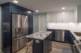 A Beautiful Kitchen using a two-tone color scheme for the painted cabinets. Warm tone on the floor helps neutralize the cold tone used in the counter tops.