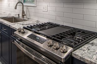A Beautiful Kitchen using a two-tone color scheme for the painted cabinets. Warm tone on the floor helps neutralize the cold tone used in the counter tops.