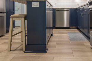 A Beautiful Kitchen using a two-tone color scheme for the painted cabinets. Warm tone on the floor helps neutralize the cold tone used in the counter tops.
