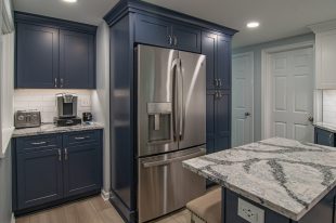 A Beautiful Kitchen using a two-tone color scheme for the painted cabinets. Warm tone on the floor helps neutralize the cold tone used in the counter tops.