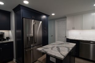 A Beautiful Kitchen using a two-tone color scheme for the painted cabinets. Warm tone on the floor helps neutralize the cold tone used in the counter tops.