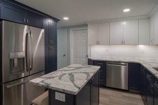 A Beautiful Kitchen using a two-tone color scheme for the painted cabinets. Warm tone on the floor helps neutralize the cold tone used in the counter tops.