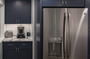 A Beautiful Kitchen using a two-tone color scheme for the painted cabinets. Warm tone on the floor helps neutralize the cold tone used in the counter tops.