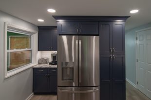 A Beautiful Kitchen using a two-tone color scheme for the painted cabinets. Warm tone on the floor helps neutralize the cold tone used in the counter tops.