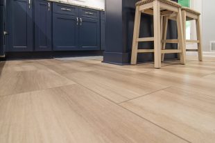 A Beautiful Kitchen using a two-tone color scheme for the painted cabinets. Warm tone on the floor helps neutralize the cold tone used in the counter tops.