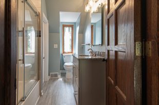 Modern Style Bathroom accenting architectural features and lighter warm tones help brighten us existing space.
